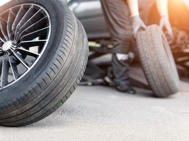 Car wheel repair shop outdoor ground . Seasonal winter tyre change at workshop. Vehicle tire repair, inspection and maintenance. Automotive garage for replace spare parts after failure breakdown